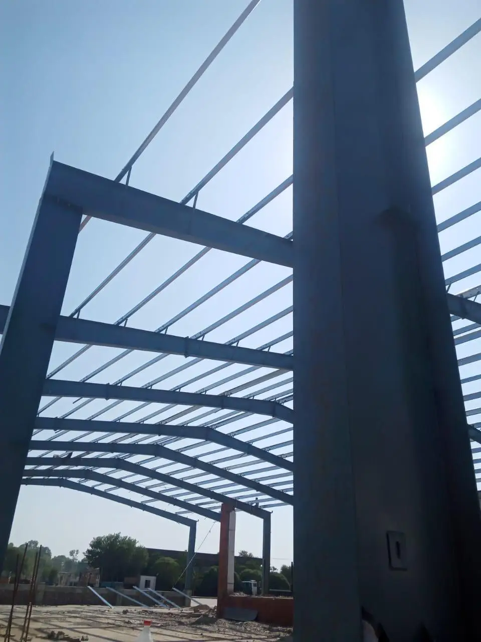 Steel portal frames and completed industrial shed at the Clearpath Export Processing Zone site in Risalpur