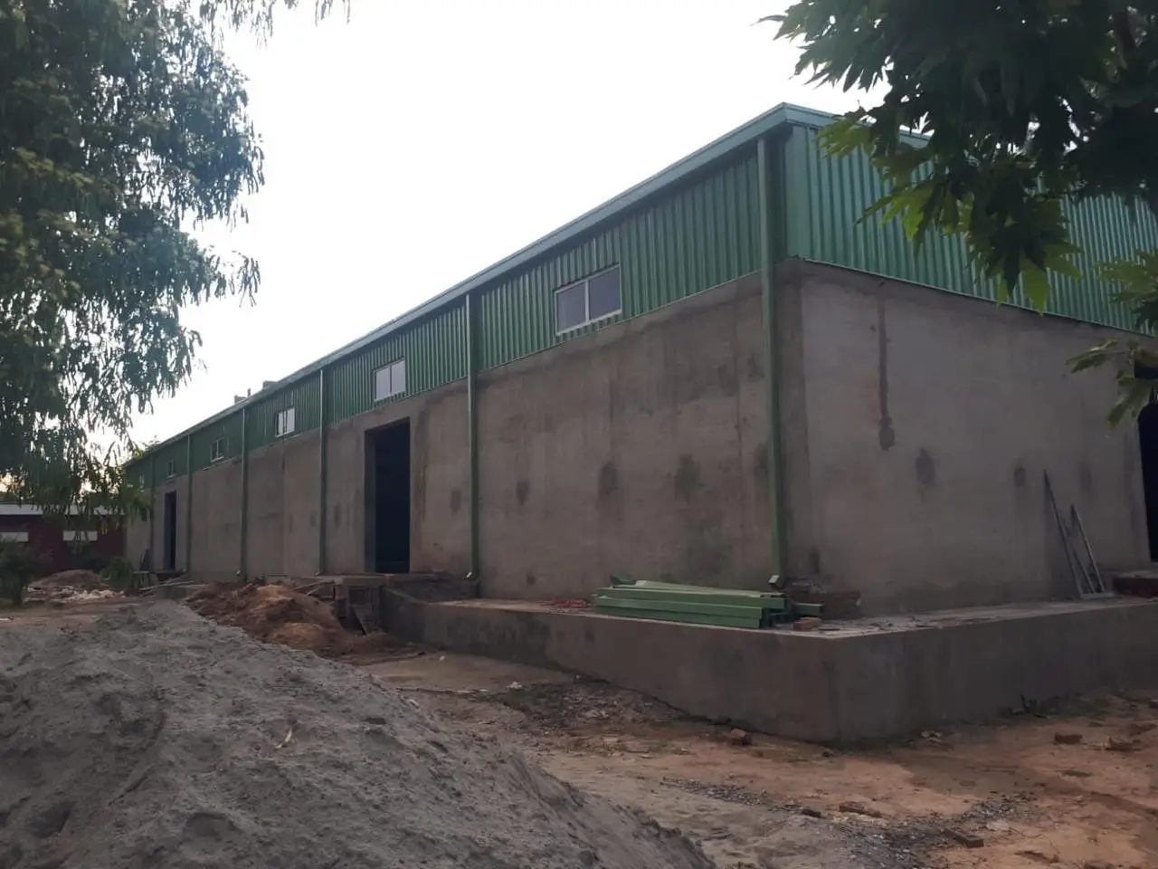 Steel-framed cantonment building with green cladding under construction in Peshawar