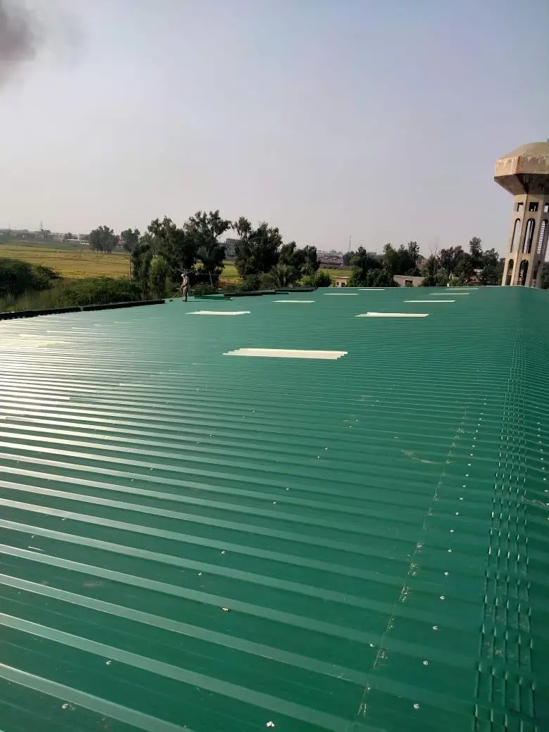 Green colour-coated roof sheeting and steel structure of the Reshma Textile manufacturing shed